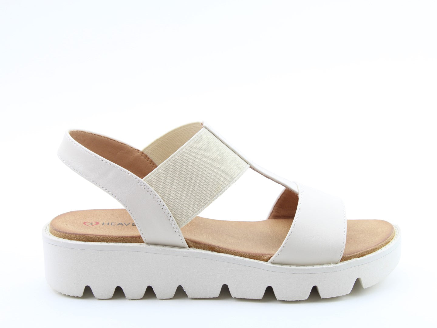 Heavenly Feet Ritz beige vegan slip-on sandals with elastic straps, cushioned footbed, and chunky white platform sole.
