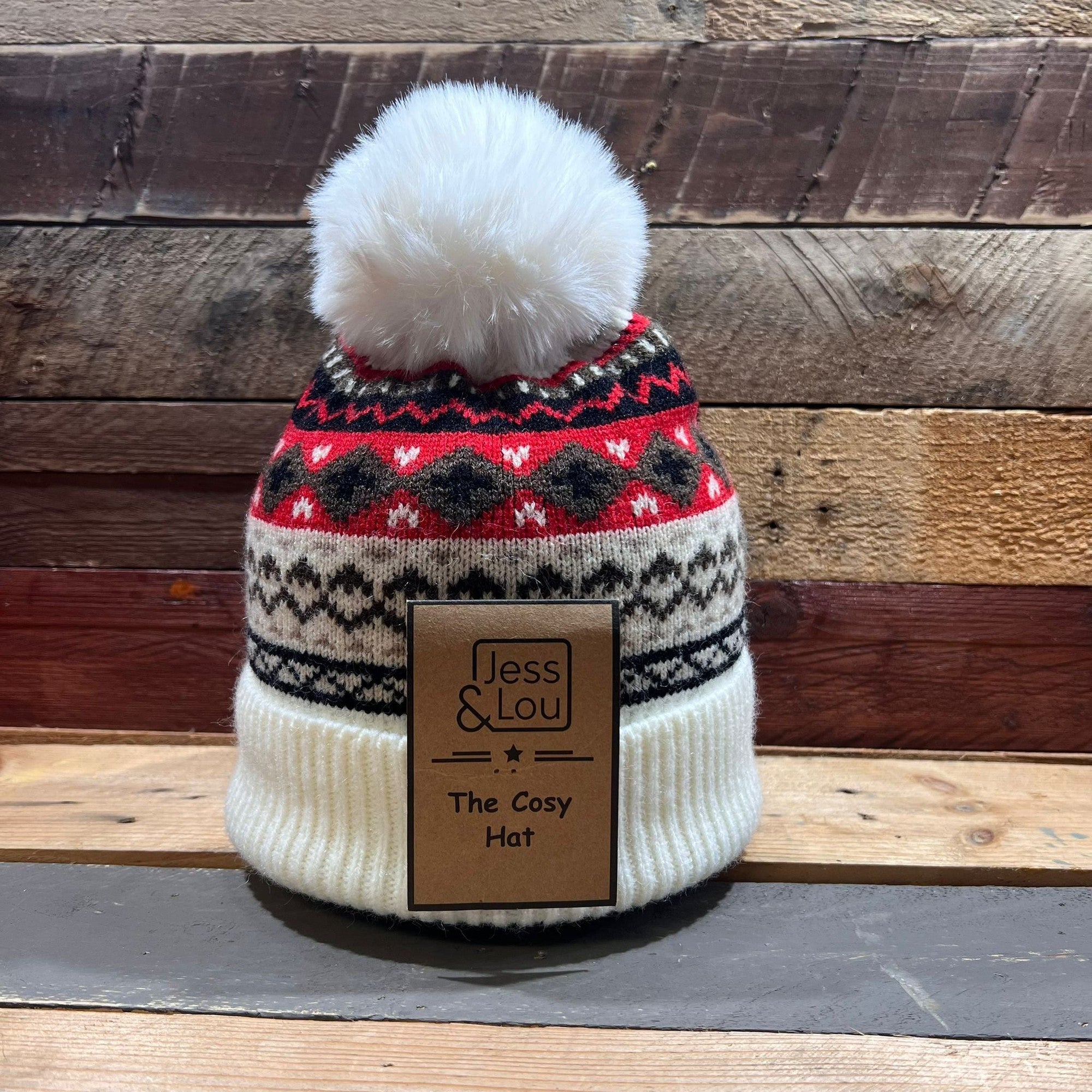 Unisex cream Nordic bobble hat with colorful Fair Isle pattern, pom-pom top, warm knit, ideal for winter stays.