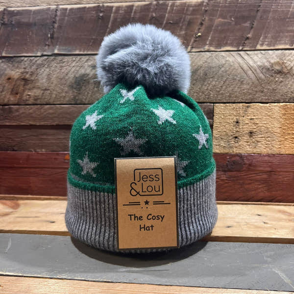 Unisex green star cozy bobble hat with grey ribbed cuff and faux fur pom-pom, featuring brand label Jess & Lou.