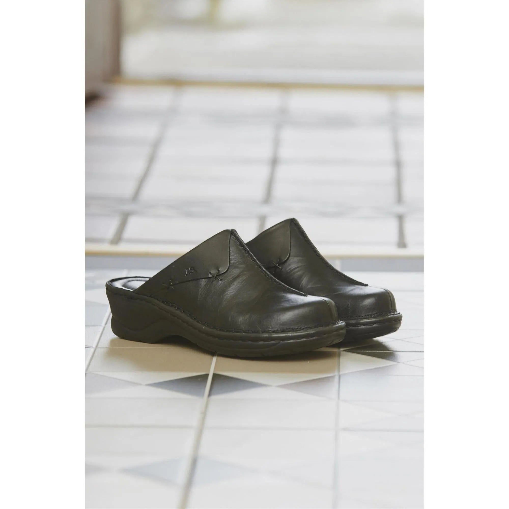 Josef Seibel Catalonia 48 black ladies' leather mules, slip-on comfort shoes with a low heel, on tiled floor.