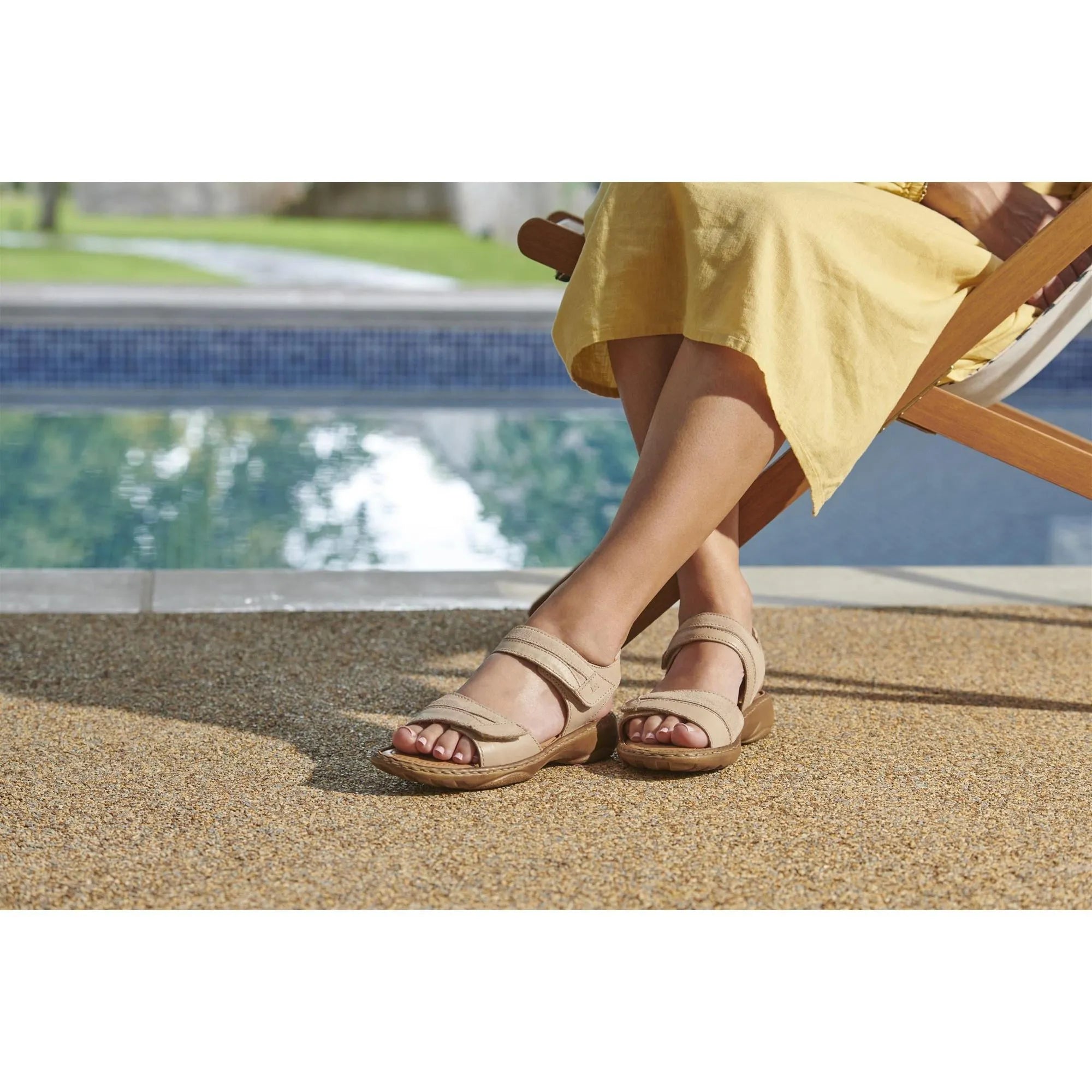 Josef Seibel Debra 19 beige leather touch fastening sandals on woman's feet by poolside, casual summer footwear for ladies.