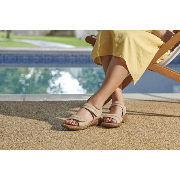 Josef Seibel Debra 19 beige leather touch fastening sandals on woman's feet by poolside, casual summer footwear for ladies.