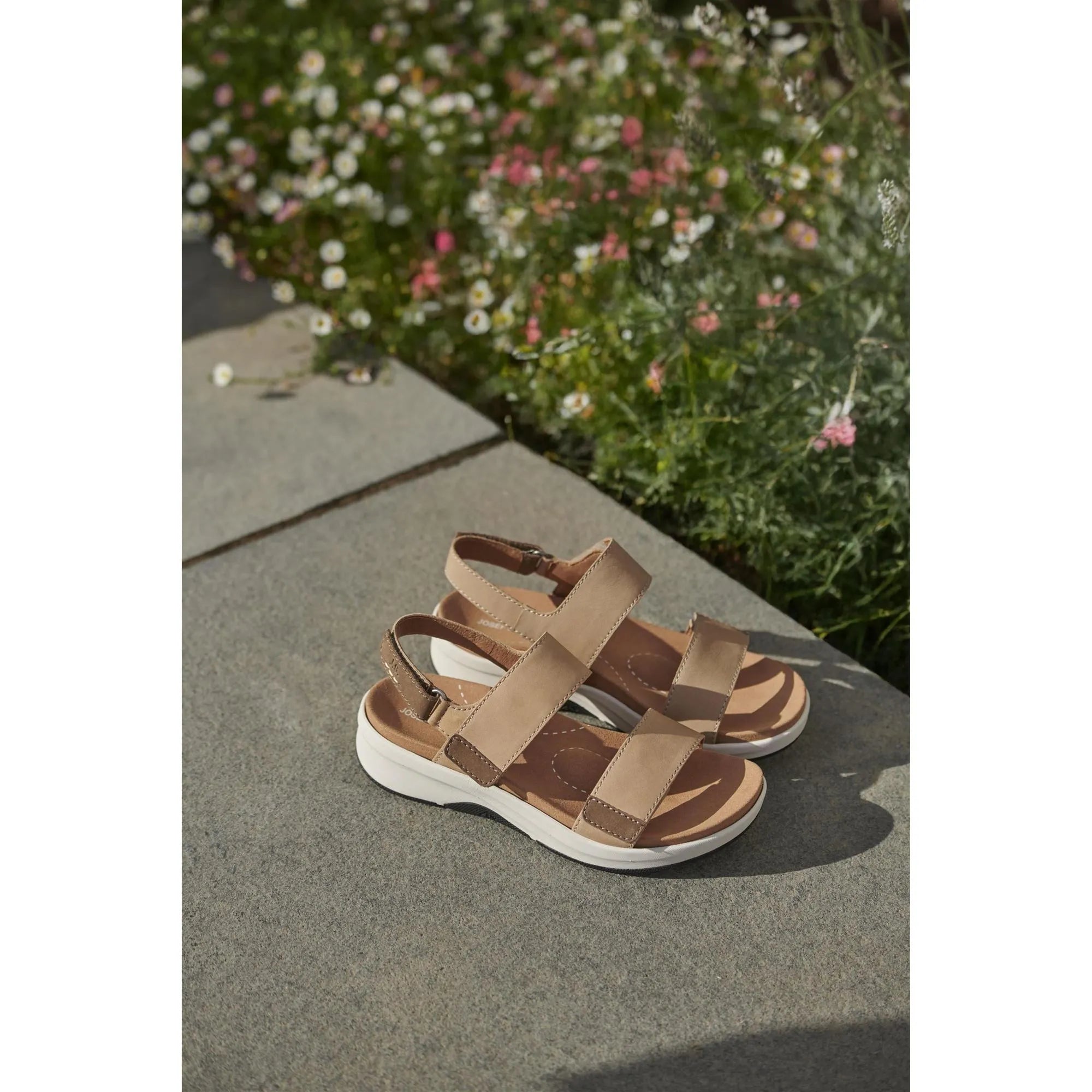 Josef Seibel Estelle 04 beige leather sandals with touch fastenings and white soles, displayed on a concrete surface.