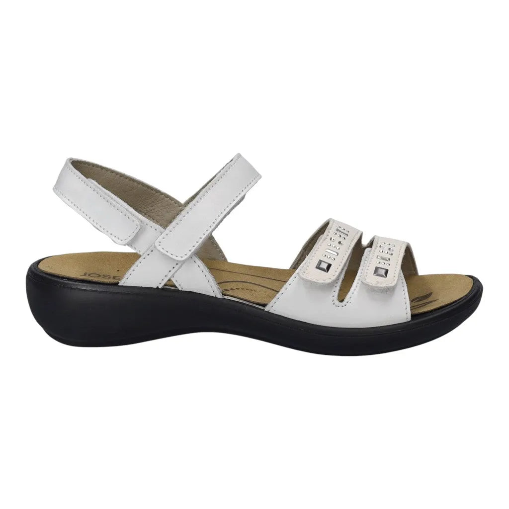 White leather touch fastening sandals with a comfortable black sole and adjustable straps for a secure fit.