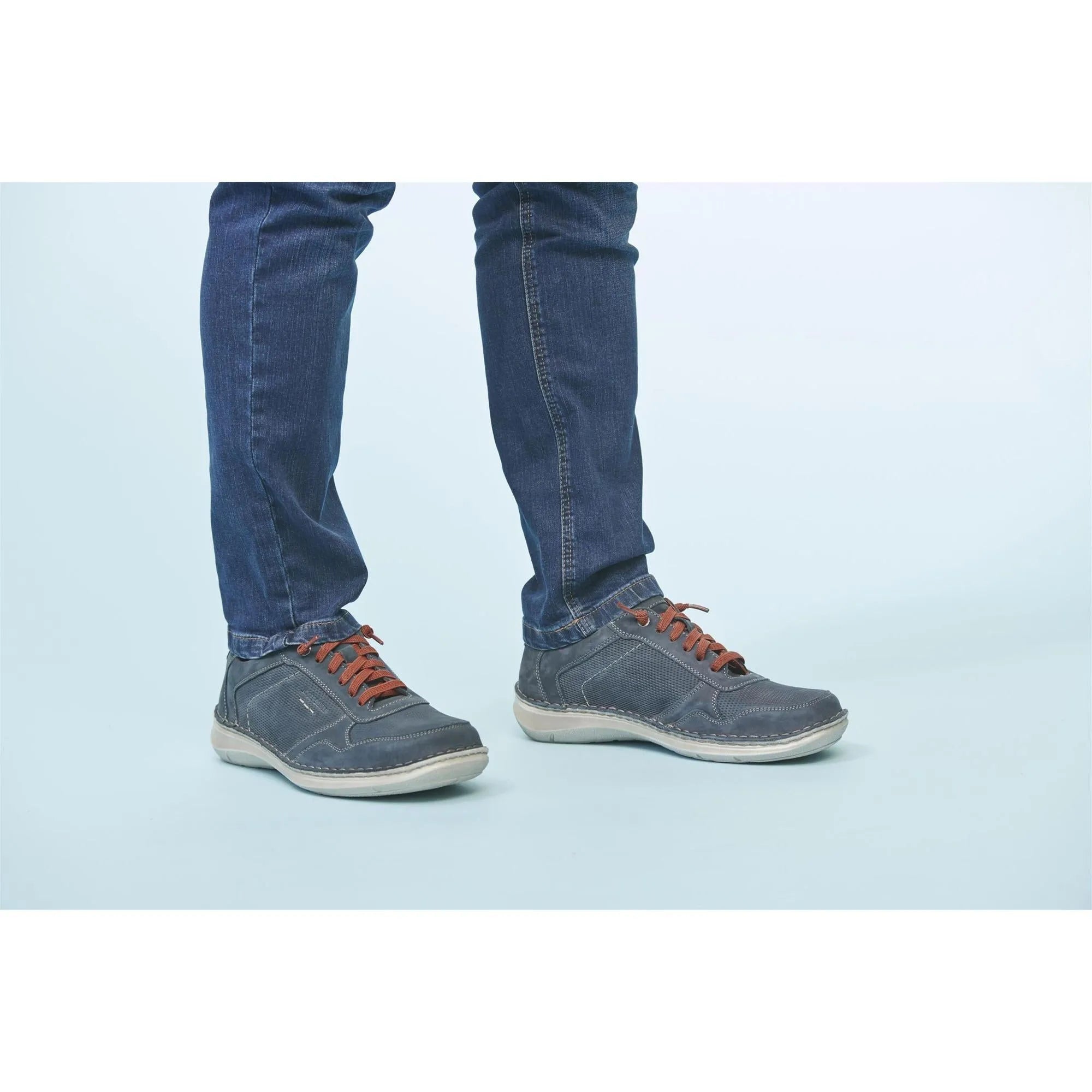 Josef Seibel New Anvers 97 men's wide indigo leather lace-up shoes with white soles, worn with jeans.