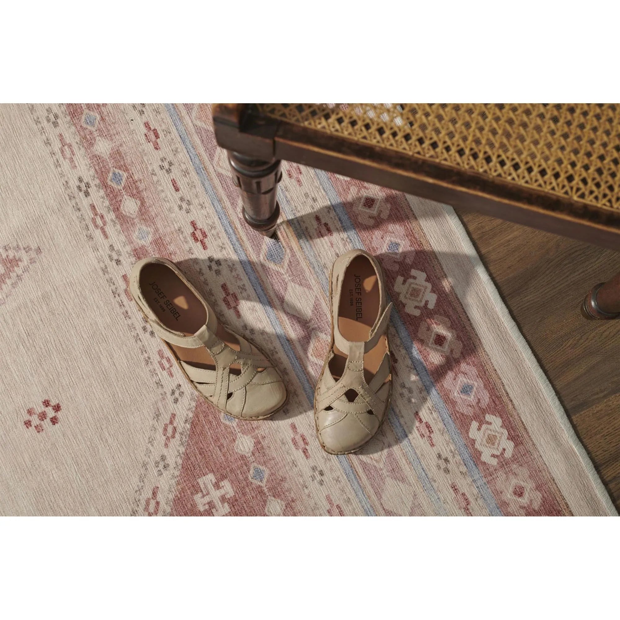 Josef Seibel Rosalie 29 ladies cream leather shoes with touch fastenings, placed on a patterned rug under a wooden chair.