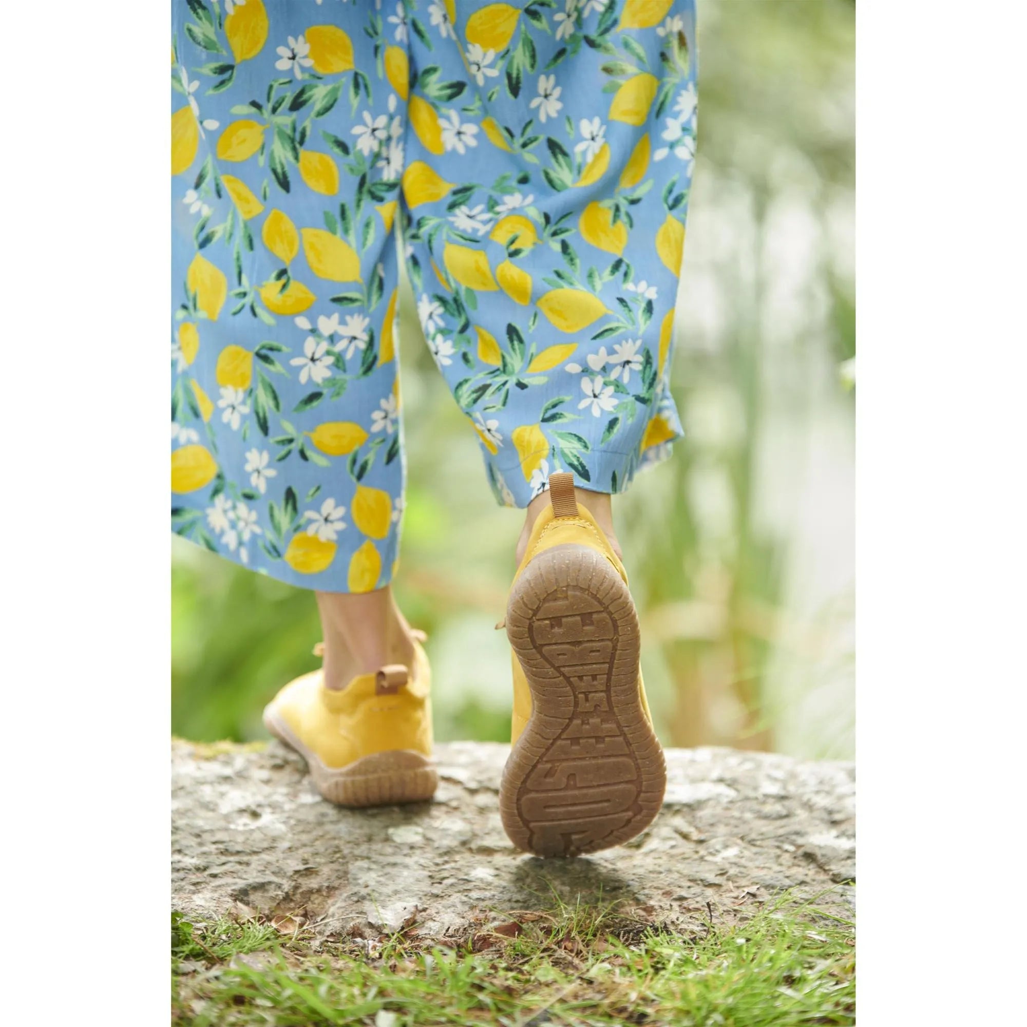 Josef Seibel Wynona 06 ladies mustard leather lace-up shoes, with beige soles, worn with floral blue pants outdoors.