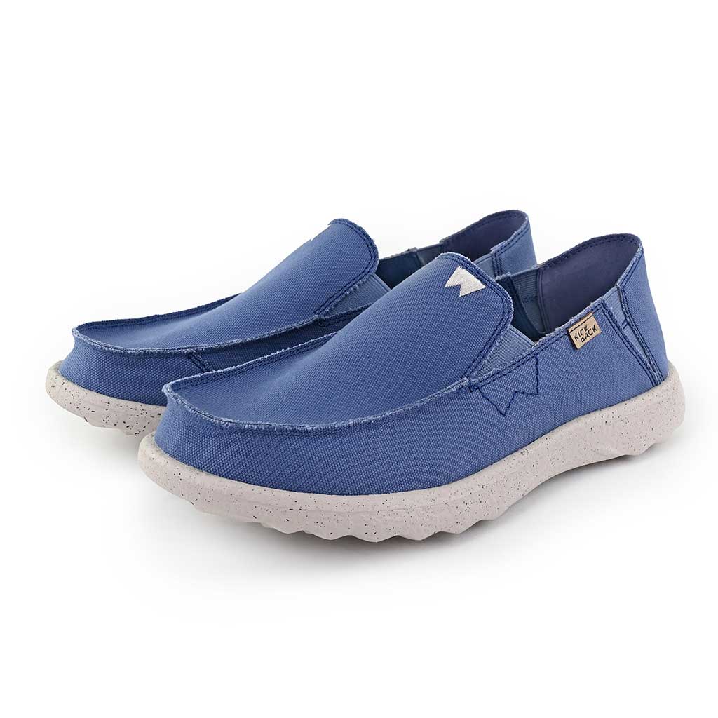 Kickback Couch 2.0 men's wide marine blue canvas slip-on loafers with arch support and speckled white foam soles.
