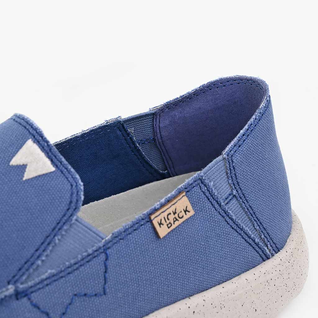Kickback Couch 2.0 men's wide marine blue canvas slip-on loafers with arch support and textured white sole.