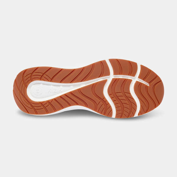 Shoe sole of Kizik Athens 2.0 men's navy leather slip-on trainers with arch support and rugged orange rubber outsole.