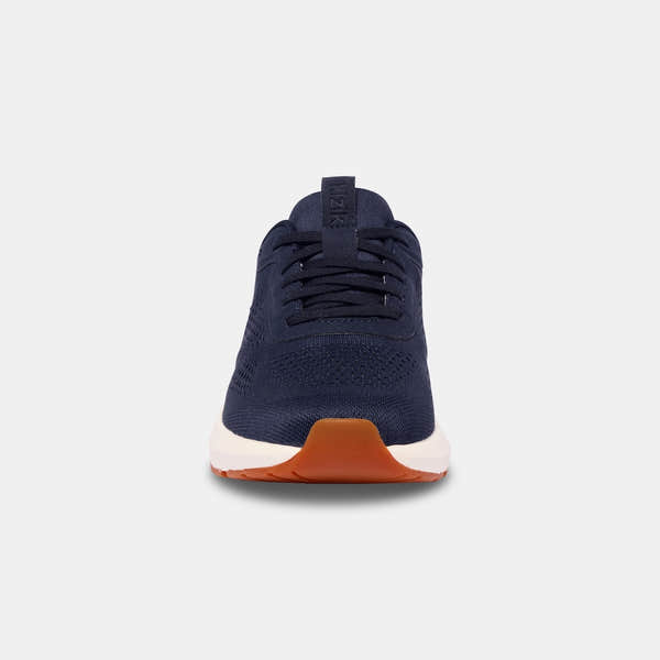 Kizik Athens 2.0 men's navy leather slip-on trainers with arch support, breathable mesh upper, and white and orange sole.