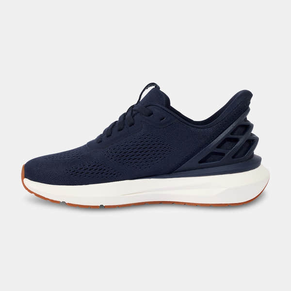 Kizik Athens 2.0 men's slip-on trainers with navy leather upper, arch support, breathable mesh design, and a white and gum rubber sole.