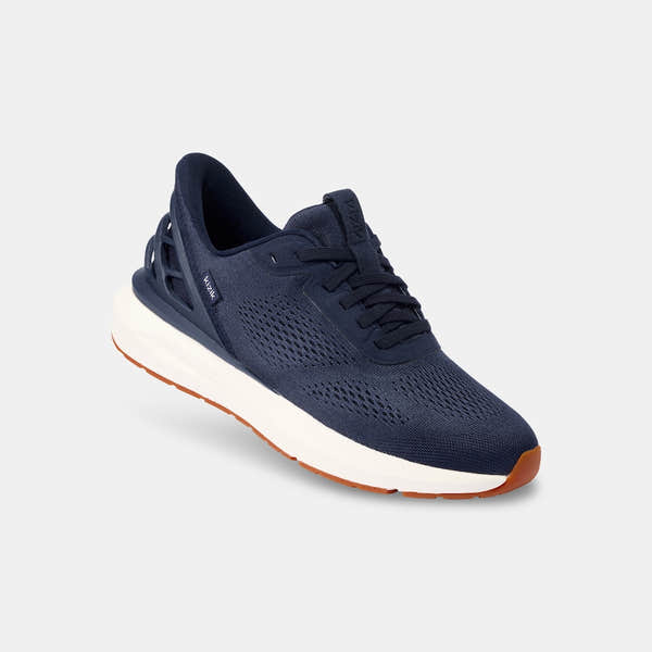 Kizik Athens 2.0 men's navy leather slip-on trainers with arch support, breathable knit upper, and cushioned white sole.