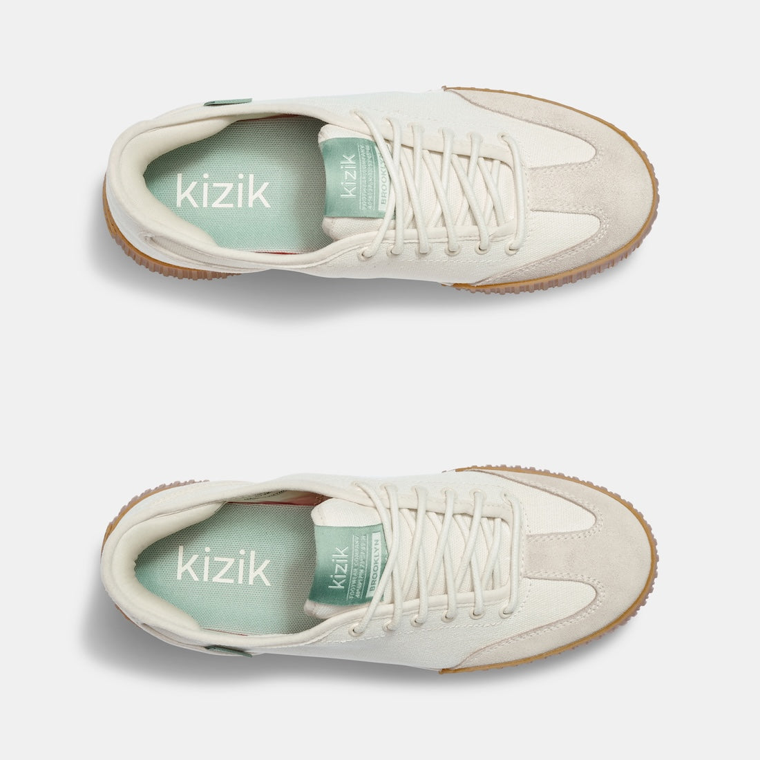 Kizik Brooklyn women's slip-on trainers with pristine leather and textile upper, arch support, and gum rubber sole.