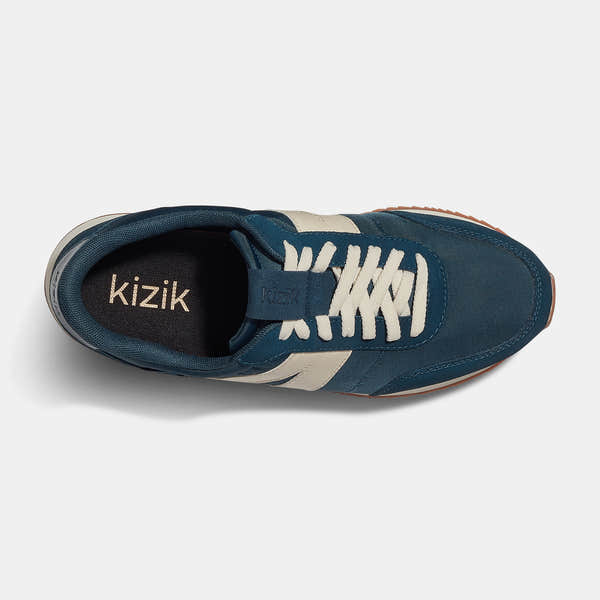 Kizik Milan unisex slip-on trainers with tidepool leather, textile upper, arch support, white laces, and rubber outsole.