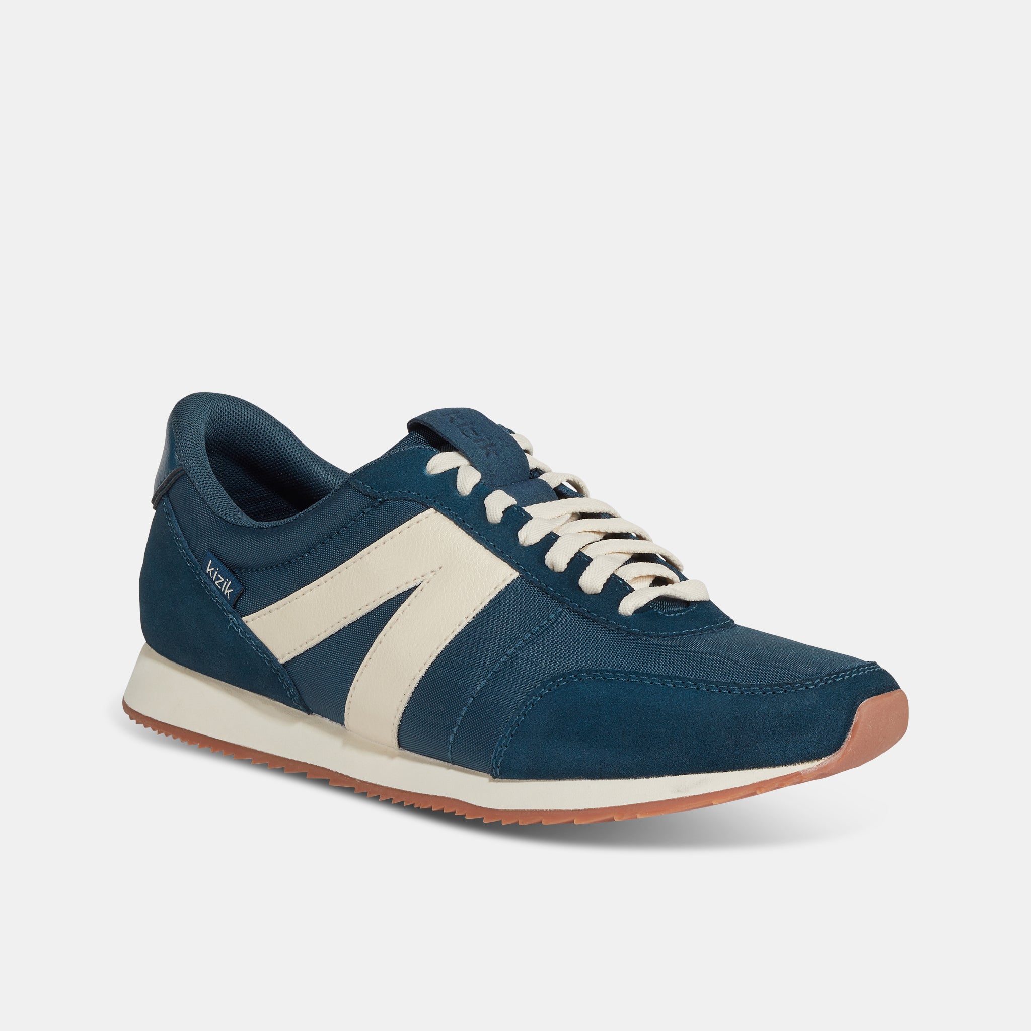 Kizik Milan unisex slip-on trainers with tidepool leather and textile upper, arch support, white laces, and rubber sole.