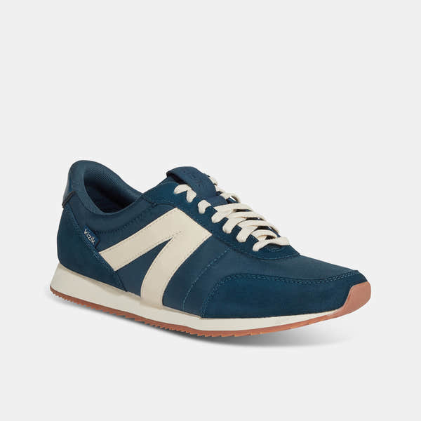 Kizik Milan unisex slip-on trainers with tidepool leather and textile upper, arch support, white laces, and rubber sole.
