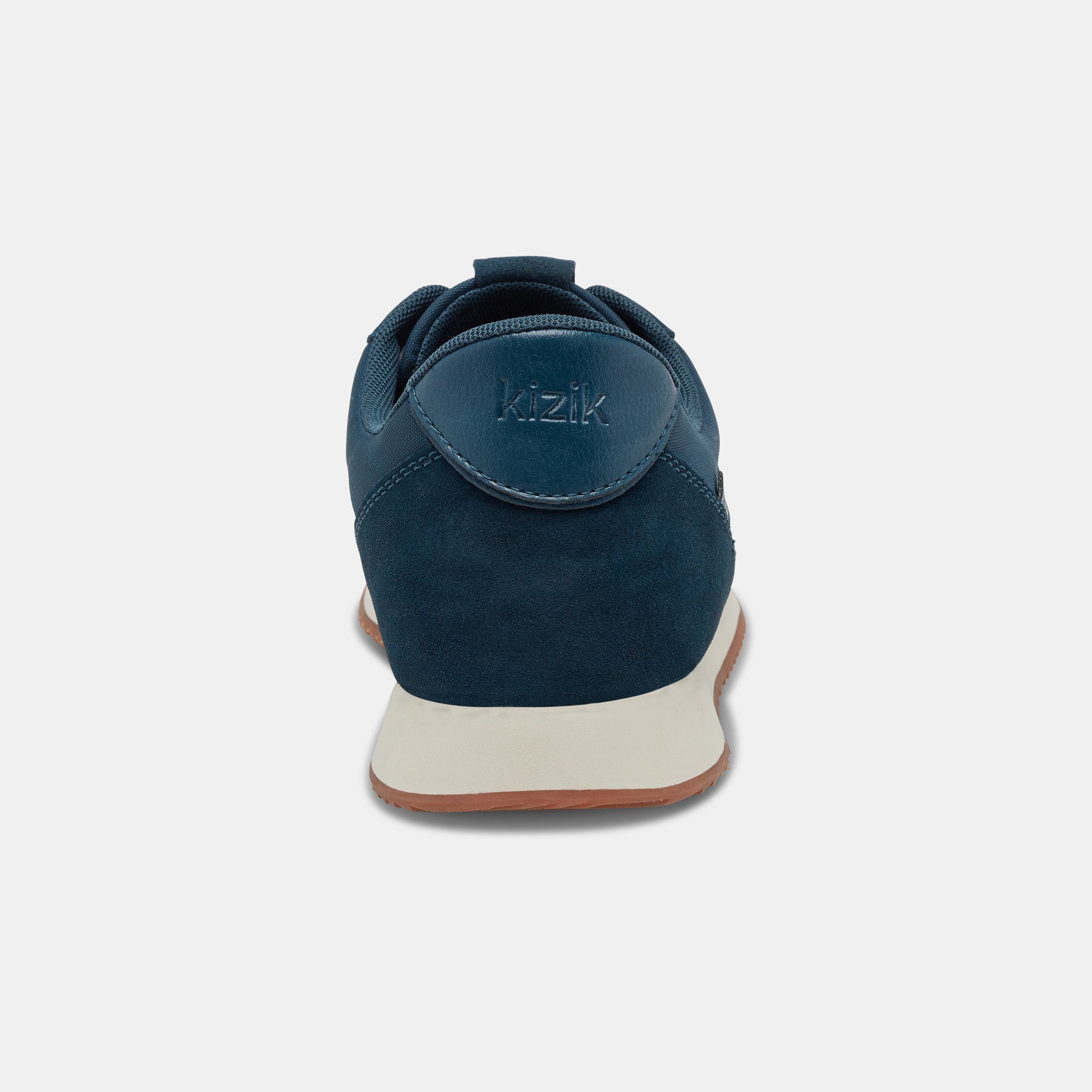 Kizik Milan unisex slip-on trainers with tidepool leather and textile upper, arch support, white sole, black accents.