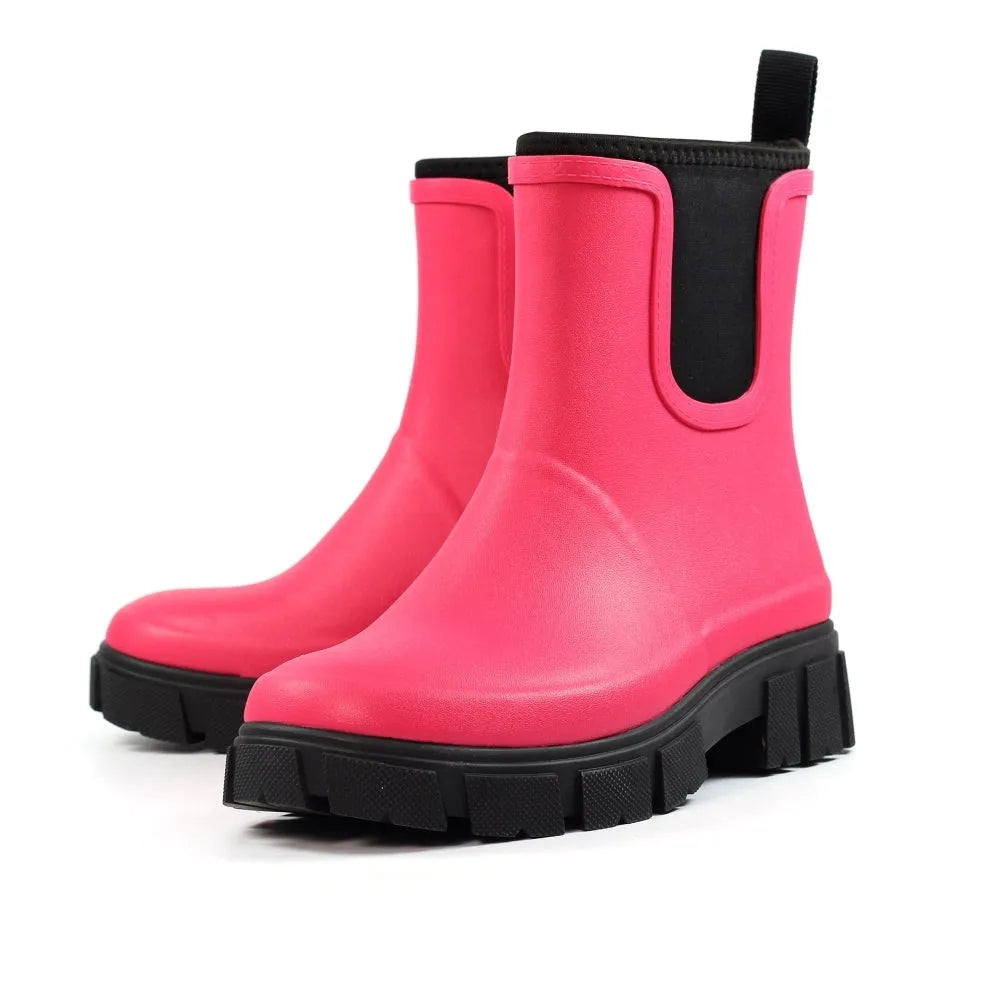 Pink waterproof elasticated wellies for women, Lazy Dogs Lake Ladies, with chunky black soles and pull tabs.