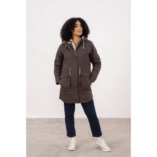 Woman wearing a brown waterproof padded coat with hood, zipper closure, and front pockets, suitable for rainy weather.