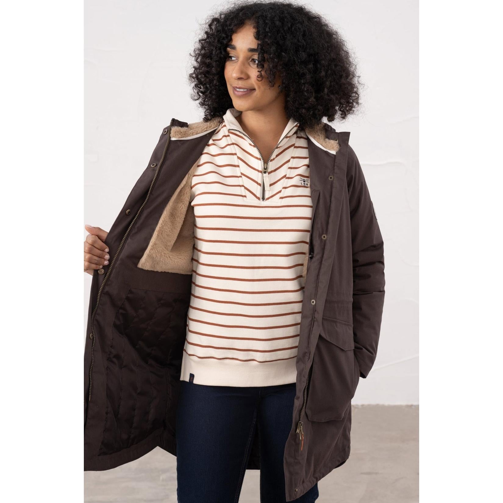 Lighthouse Isobel Cocoa women's padded waterproof coat with quilted lining, showing a woman wearing it open over a striped sweater.