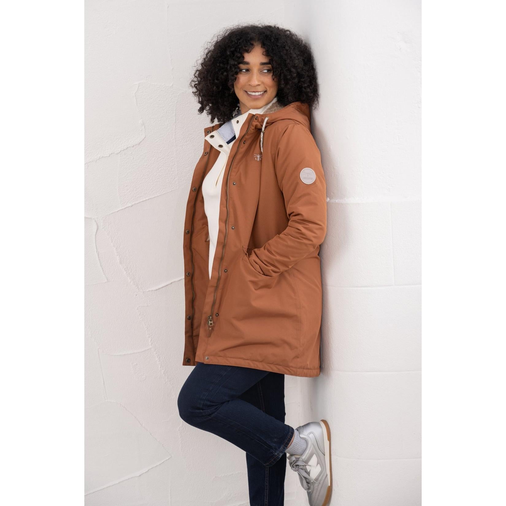 Lighthouse Scarlet Ladies Waterproof Coat in Rust color, featuring a hood, insulated lining, and functional pockets.