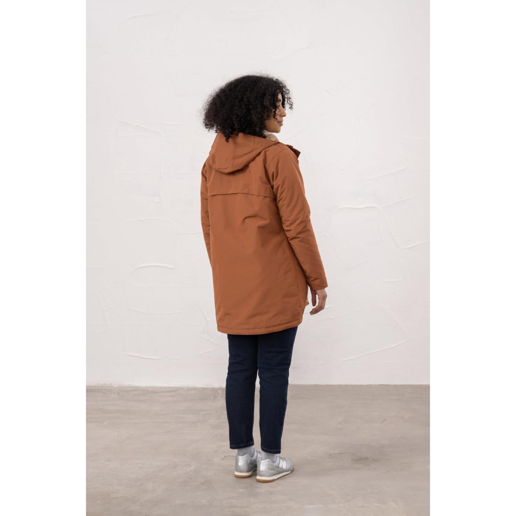 Lighthouse Scarlet Ladies Waterproof Coat in Rust color, hanging mid-length, with hood and quilted design, suitable for rainy weather.