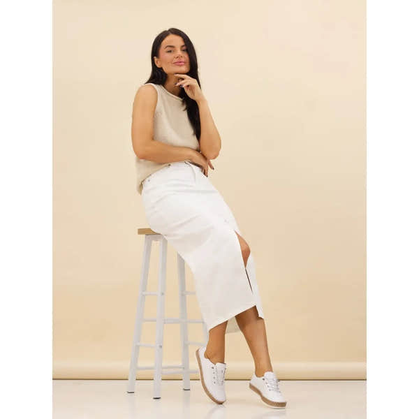 Lunar FLE050 Evie Ladies White Leather Elasticated Shoes on model with beige background, stylish and comfortable slip-ons.