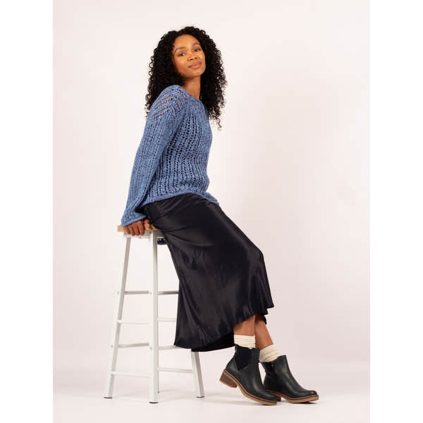 Lunar GLC013 Conrad Ladies Navy Pull-On Ankle Boots with low heel and sleek design, paired with a black satin skirt and cozy socks.