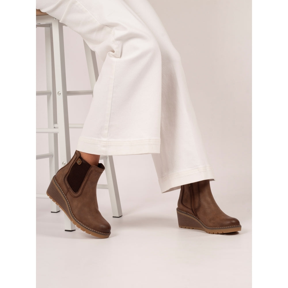 Lunar GLC014 Connie Ladies Brown Side Zip Ankle Boots with wedge heel and pull tab, styled with white wide-leg pants.