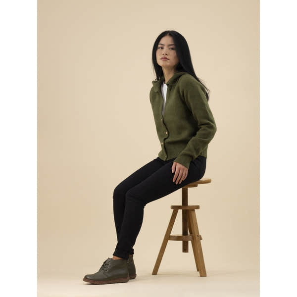 Lunar GLR014 Claire II women's green leather ankle boots with zip and lace detailing, worn with black jeans and a green jacket.