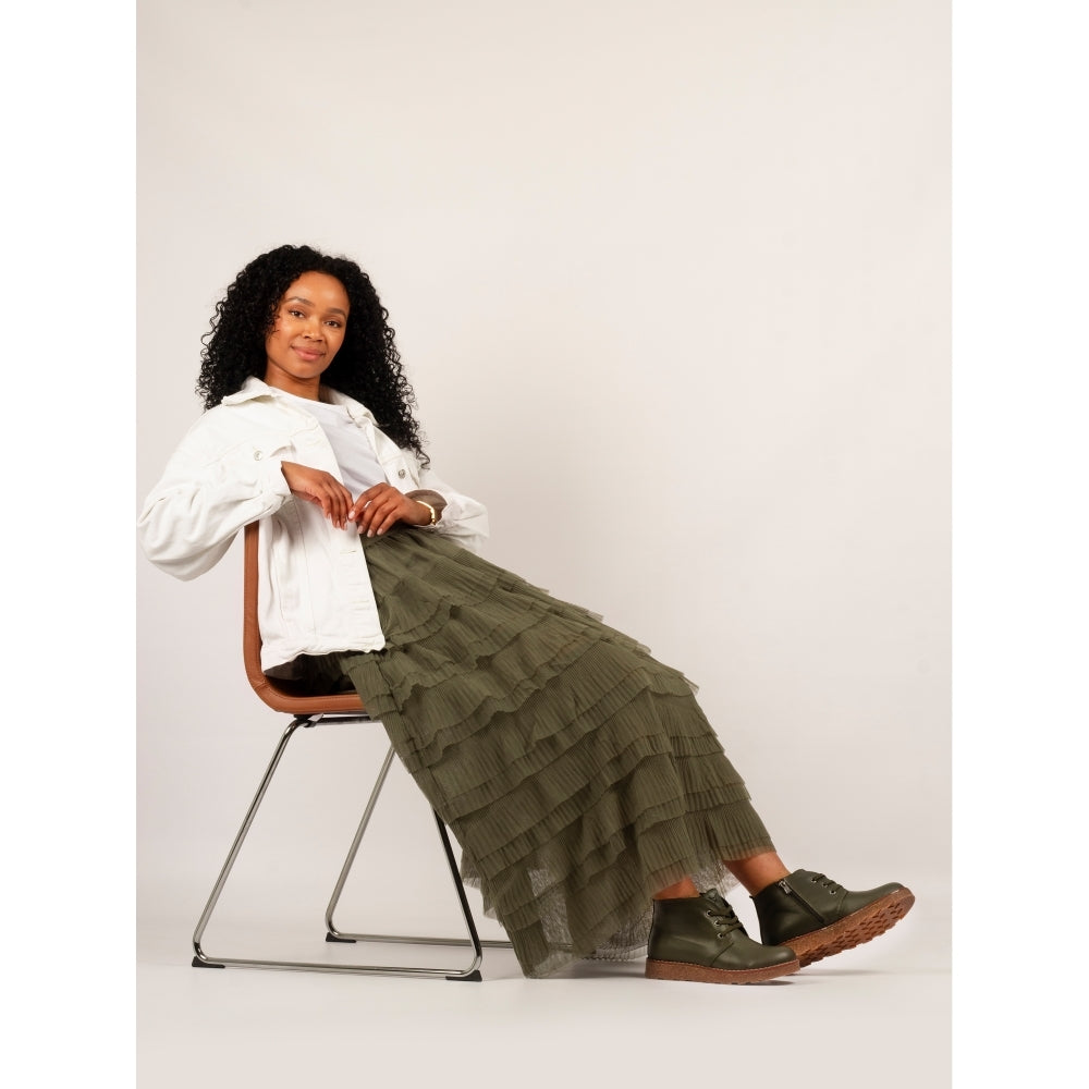 Lunar GLR126 Claire III women's olive leather ankle boots with zip and lace detail, paired with a long green tiered skirt and white jacket.