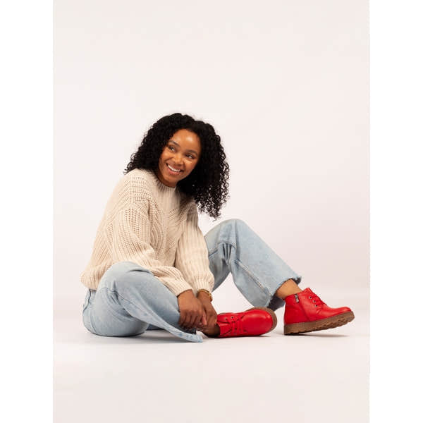 Lunar GLR126 Claire III women's red leather ankle boots with zip and lace-up design, chunky sole, styled with light jeans and beige sweater.