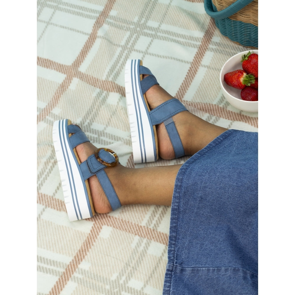 Lunar JLB011MB Elise Ladies Mid Blue Buckle Sandals, open-toe, strappy design with buckle detail, worn with jeans on patterned rug.