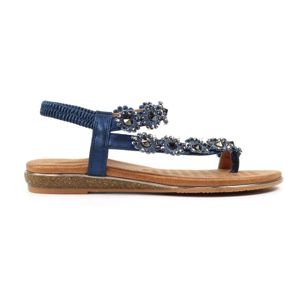 Lunar JLH455 Charlotte II Ladies navy elasticated sandal with embellished floral strap, flat sole, and cushioned footbed.