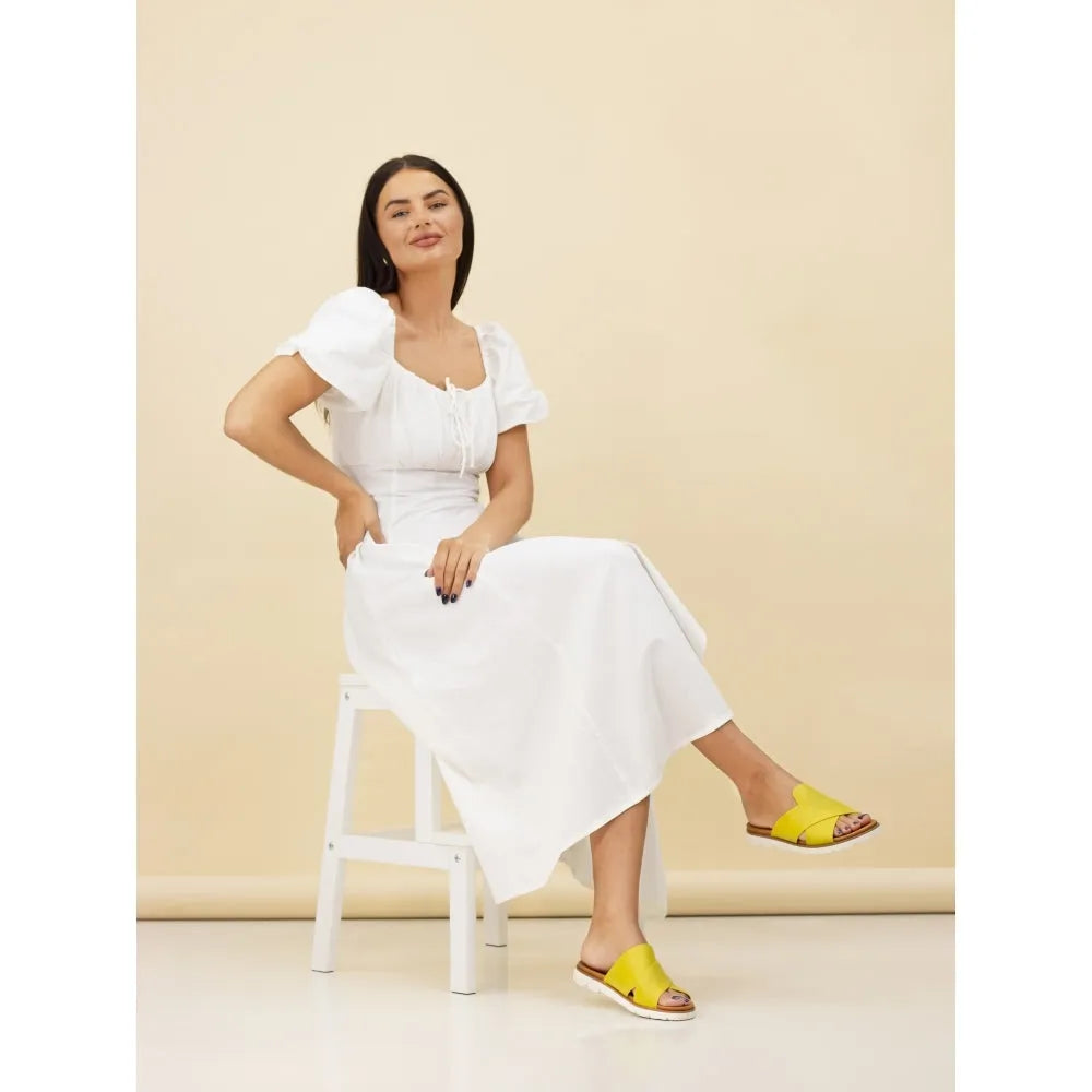 Lunar JLH518 Chloe Ladies Lime Slip-On Mules, open-toe flat sandals with wide straps, worn by a woman in a white dress.