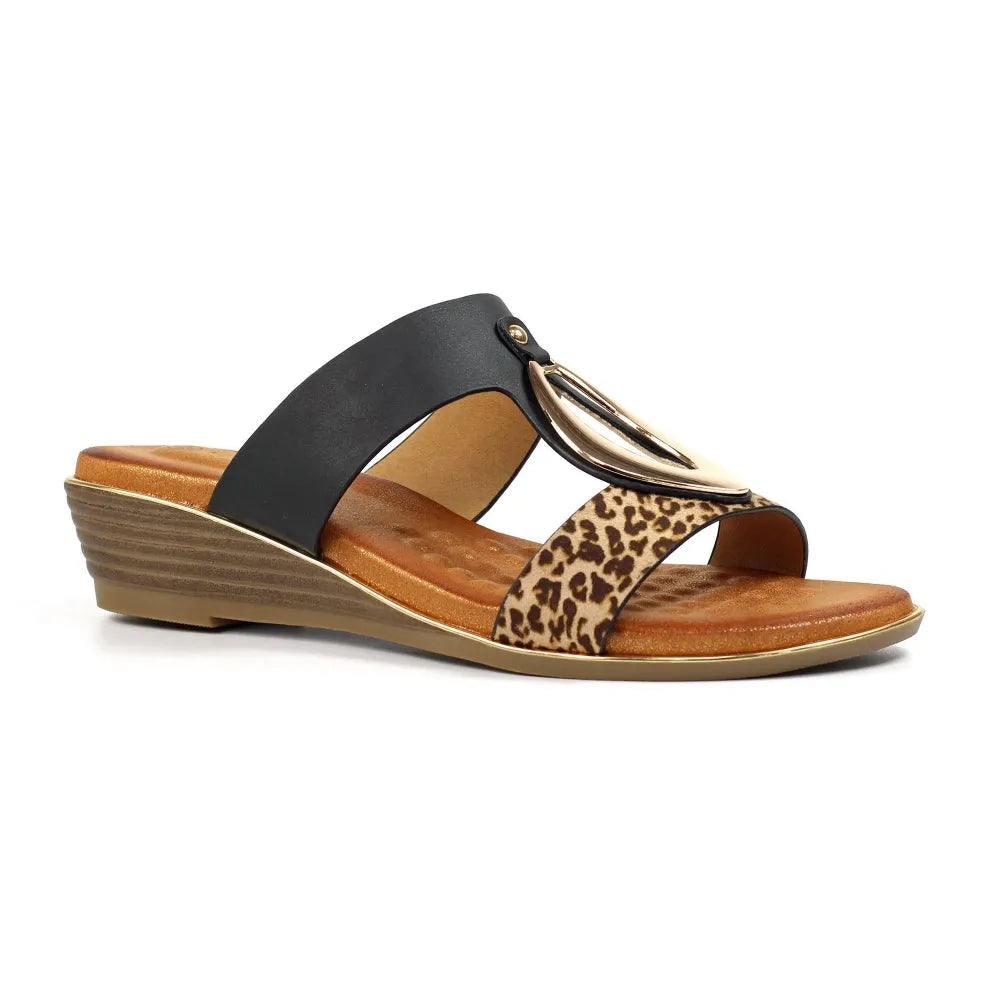 Black slip-on mule with leopard print and gold metal embellishment, cushioned insole, and wedge heel.