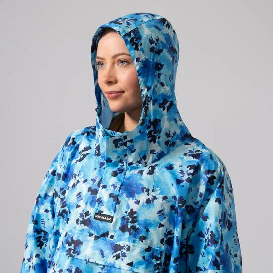 Unisex blue daze festival poncho with hood, camo pattern, waterproof fabric, and front pocket, ideal for outdoor events.