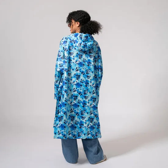 Unisex festival poncho in blue daze floral pattern, lightweight, waterproof, Hooded, stylish rain Protection for outdoor events.