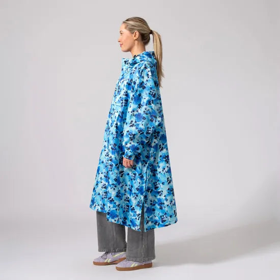 Unisex blue daze festival poncho with hood, oversized fit, lightweight waterproof fabric, ideal for outdoor events.