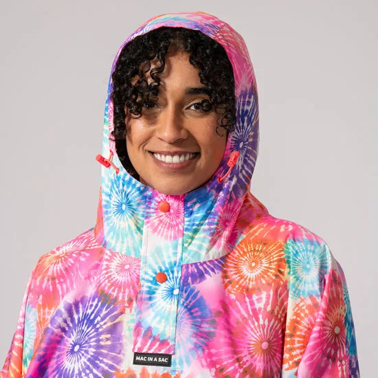 Unisex tie-dye festival poncho with hood, colorful bright pink, blue, purple, and orange firework patterns, 