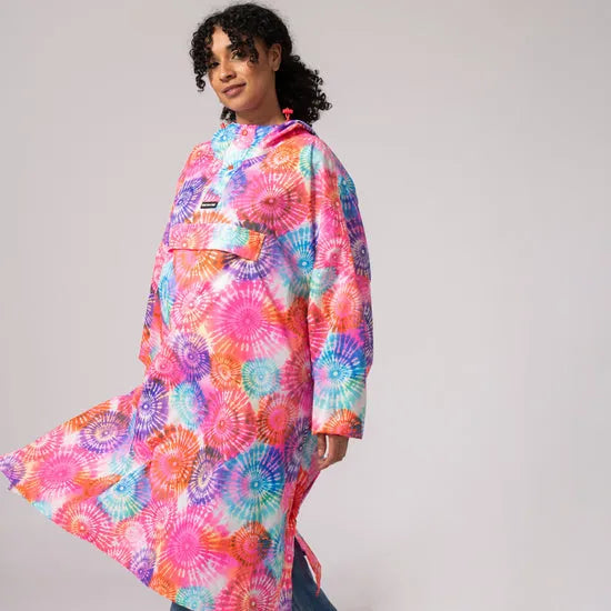 Unisex festival poncho with tie-dye spiral pattern, vibrant pink, orange, blue, and purple colors, loose fit, outdoor wear.