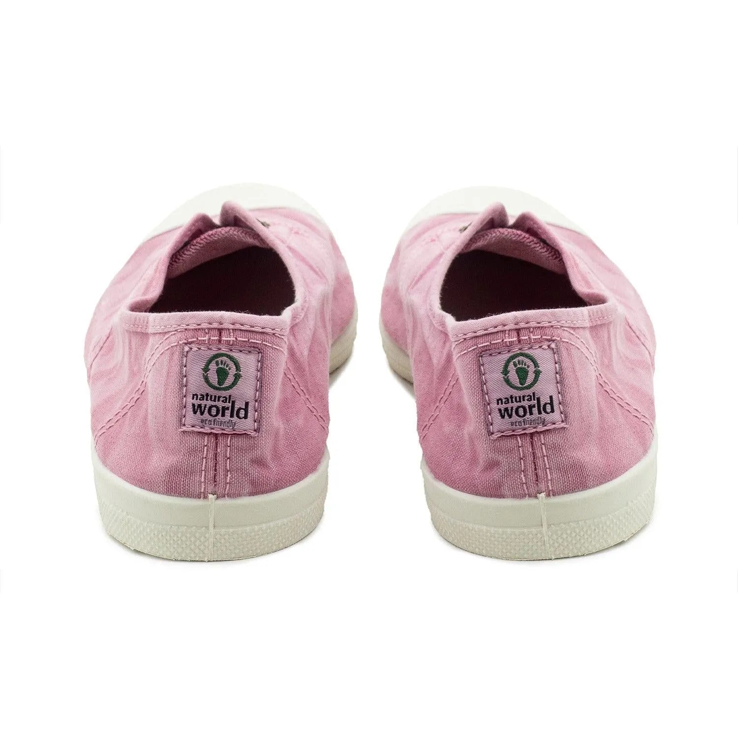Pink vegan slip-on shoes for women with natural world logo on back strap, fabric upper, and white rubber sole.