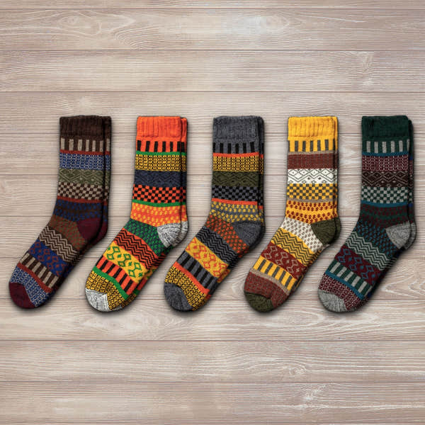 Unisex Nordic wool socks in grey, orange, black, yellow, and green with Nordic patterns and geometric designs.