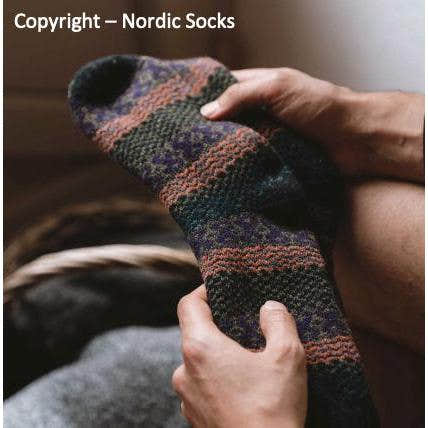 Nordic unisex Tore wool sock in blue, featuring colorful striped and geometric patterns, cozy and warm wool material.