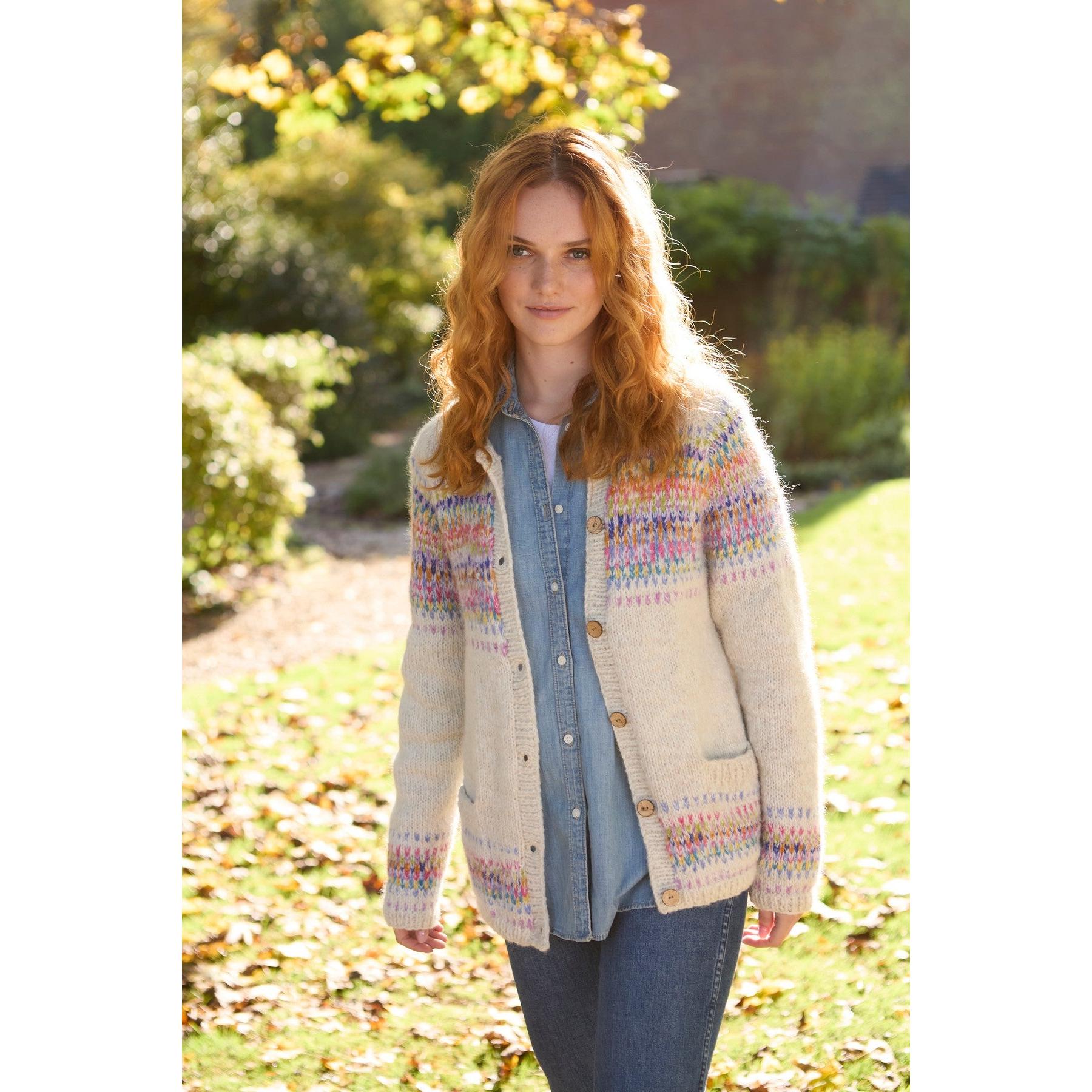 Pachamama Arundel Cardigan in Oatmeal, cozy knit sweater with colorful Fair Isle pattern, button-front, worn by a woman outdoors.