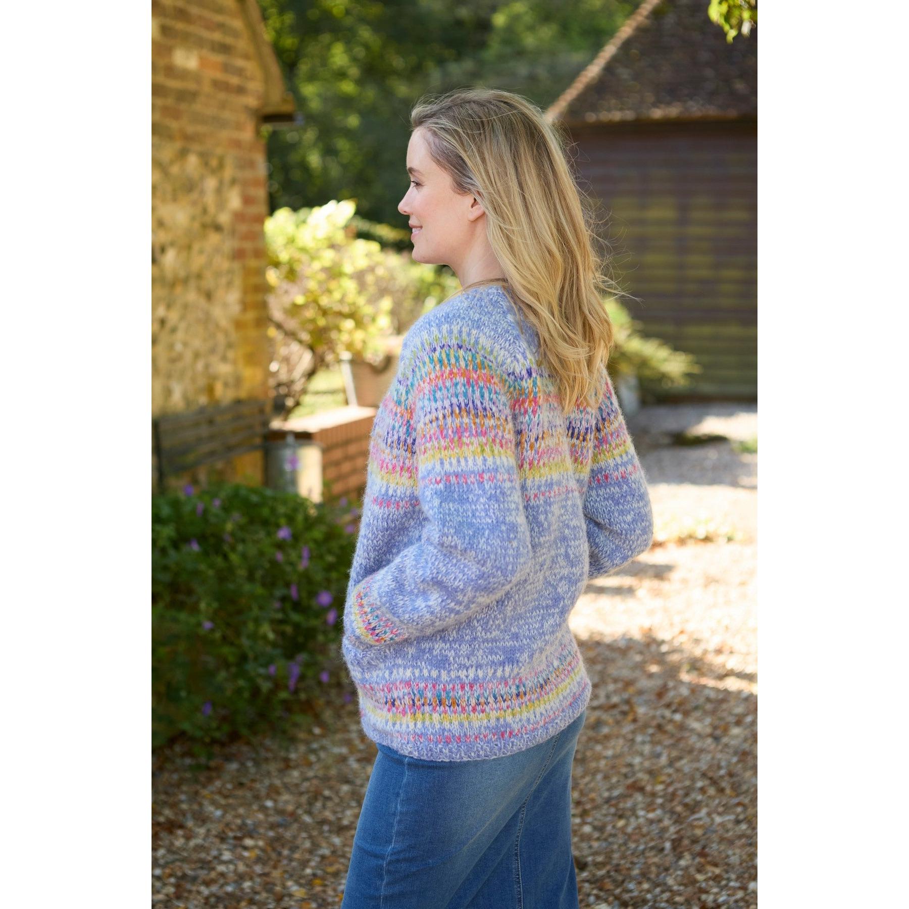 Pachamama Arundel Cardigan Sky, multicolor knitted sweater, long sleeves, cozy fit, outdoor setting.