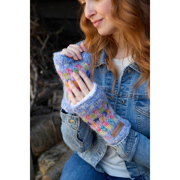 Pachamama Arundel Sky handwarmer gloves with colorful knit pattern, worn by woman outdoors, made of warm, soft material.