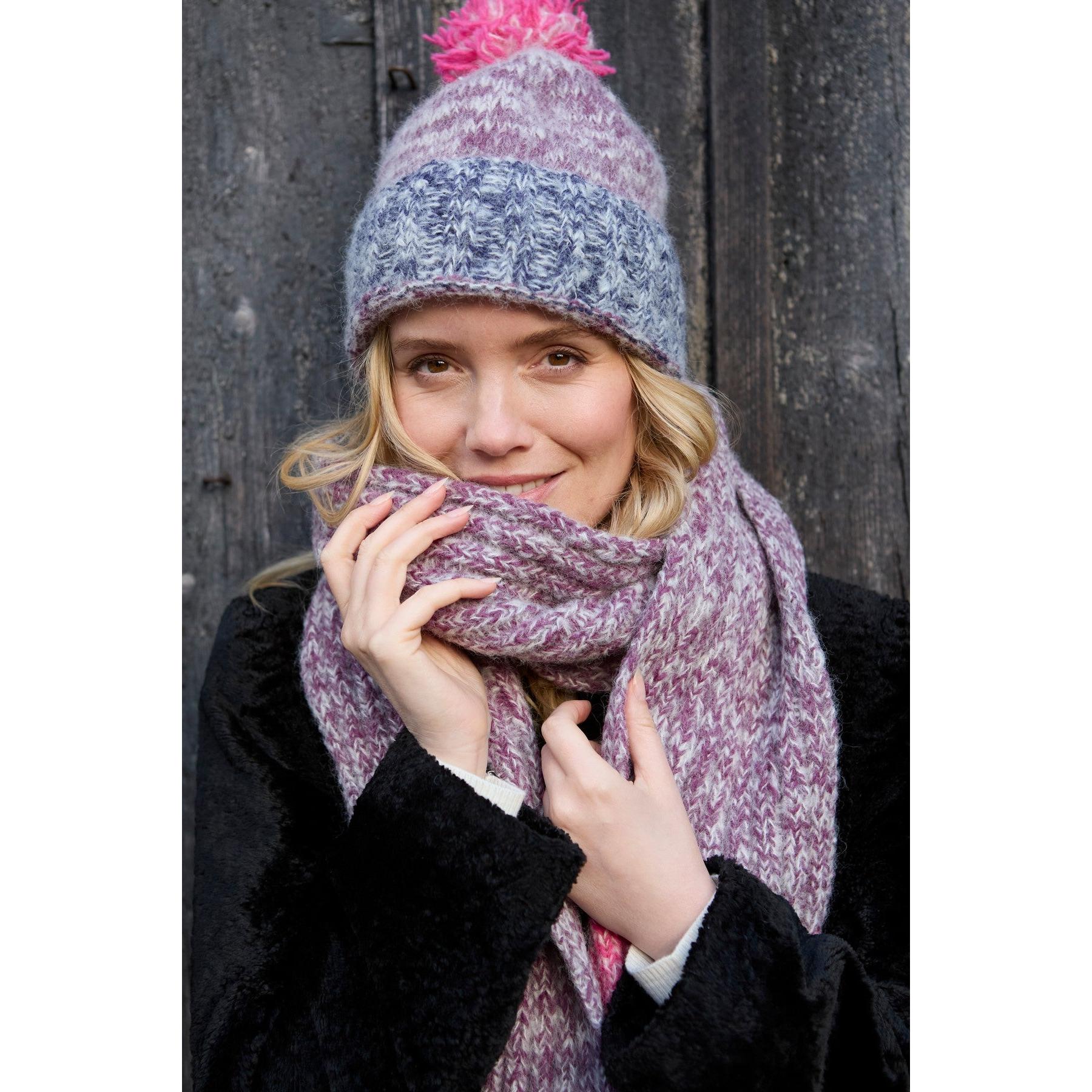 Pachamama Berlin purple bobble beanie and matching knit scarf worn by woman, cozy winter accessory, stylish and warm.