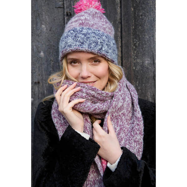 Pachamama Berlin purple bobble beanie and matching knit scarf worn by woman, cozy winter accessory, stylish and warm.